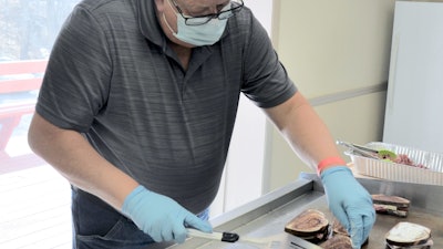 Mack Manufacturing Supervisor John Tidd grills corned beef Reuben sandwiches for employees at the Company’s East Arlington Road facility, in Arlington, Vt., Wednesday, March 17, 2021, in honor of the plant reaching 1,000 days without a lost-time accident.