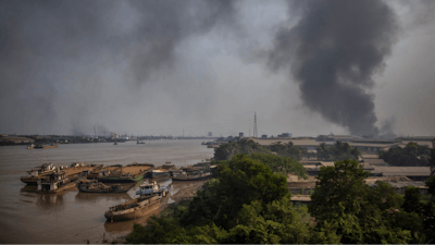 Black smoke billows from the industrial zone of Hlaing Thar Yar township in Yangon, Myanmar Sunday, March 14, 2021.