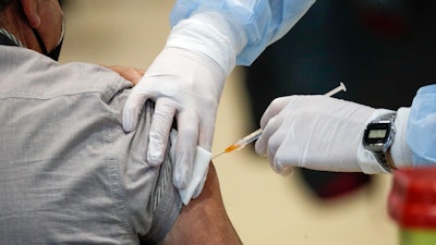 In this file photo, staff members administer the AstraZeneca vaccine at La Nuvola (The Cloud) convention center that was temporarily turned into a COVID-19 vaccination hub in Rome.