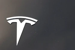 The company logo is seen on the hood of an unsold Tesla at a dealership late Sunday, Aug. 9, 2020, in Littleton, Colo. On Monday, March 15, 2021, the U.S. government’s highway safety agency said it is sending a team to Detroit to investigate a crash involving a Tesla that drove beneath a semitrailer.