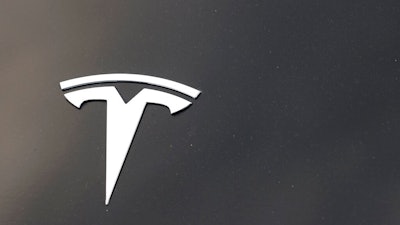 The company logo is seen on the hood of an unsold Tesla at a dealership late Sunday, Aug. 9, 2020, in Littleton, Colo. On Monday, March 15, 2021, the U.S. government’s highway safety agency said it is sending a team to Detroit to investigate a crash involving a Tesla that drove beneath a semitrailer.