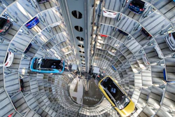 A Volkswagen ID.3 (l) and ID.4 stand inside a delivery tower in Wolfsburg, Germany, Friday, March 26, 2021. Volkswagen started deliveries of the all-electric SUV on 26 March 2021.