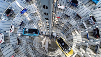 A Volkswagen ID.3 (l) and ID.4 stand inside a delivery tower in Wolfsburg, Germany, Friday, March 26, 2021. Volkswagen started deliveries of the all-electric SUV on 26 March 2021.