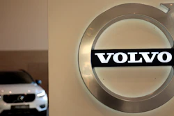 This file photo a Volvo car is parked behind the Volvo logo in the lobby of the company's corporate headquarters, in Brussels.