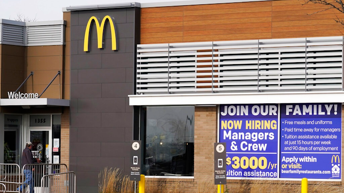 In this Nov. 19, 2020, file photo, a hiring sign is displayed outside of McDonald's in Buffalo Grove, Ill. On Wednesday, April 14, 2021, McDonald’s said the company will mandate worker training to combat harassment, discrimination and violence in its restaurants worldwide starting in 2022.