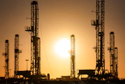The morning sun rises behind oil rigs sitting in storage Saturday, Feb. 6 at a yard outside of Odessa, Texas.