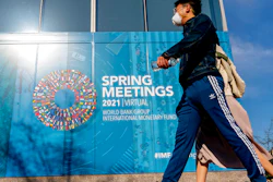 A poster displayed on the International Monetary Fund building, April 5, 2021, Washington.