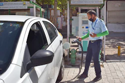 A driver of an electric car charges his vehicle at public charging station in New Delhi, April 1, 2021.