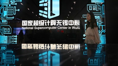 A woman walks in the hallway of the National Supercomputer Center in Wuxi, which hosts the Shenwei (Sunway) TaihuLight supercomputer.