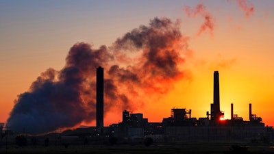 In this July 27, 2018, file photo, the Dave Johnson coal-fired power plant is silhouetted against the morning sun in Glenrock, Wyo. More than 300 businesses and investors are calling on the Biden administration to set an ambitious climate change goal that would cut U.S. greenhouse gas emissions by at least 50% below 2005 levels by 2030.