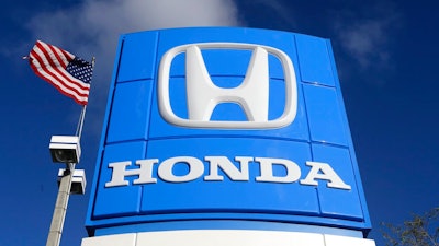 This Tuesday, Jan. 13, 2015, file photo shows a sign at a Honda dealership in Miami Lakes, Fla. Japanese automaker Honda said Friday, April 23, 2021 that it plans to phase out all of its gasoline-powered vehicles in North America by 2040, making it the latest major automaker with a goal of becoming carbon neutral. The announcement came as leaders of the major global economies met for President Joe Biden's climate summit.