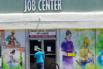 In this May 7, 2020, file photo, a person looks inside the closed doors of the Pasadena Community Job Center in Pasadena, Calif., during the coronavirus outbreak. While most Americans have weathered the pandemic financially, about 38 million say they are worse off now than before the outbreak began in the U.S. According to a new poll from Impact Genome and The Associated Press-NORC Center for Public Affairs Research 55% of Americans say their financial circumstances are about the same now as a year ago, and 30% say their finances have improved.