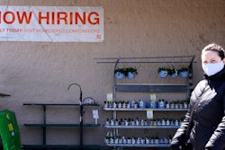 A hiring sign is seen outside home improvement store in Mount Prospect, Ill., Friday, April 2, 2021.