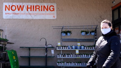 A hiring sign is seen outside home improvement store in Mount Prospect, Ill., Friday, April 2, 2021.