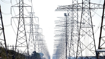 This Tuesday, Feb. 16, 2021 file photo shows power lines in Houston. The electric grid manager for most of Texas issued an electricity conservation watch Tuesday, April 13, 2021 appealing to customers to conserve electricity despite weather conditions typical for spring.