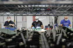 Ford Motor Co. line workers put together ventilators at the Ford Rawsonville plant, Ypsilanti Township, Mich., May 13, 2020.