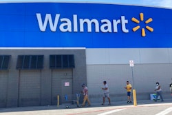 Customers wait in line outside a Walmart Supercenter store, due to COVID-19 restrictions on store capacity, Wednesday, April 7, 2021, in Miami. Walmart is moving more of its workers full time, with the goal of having two-thirds of its U.S. store hourly jobs be full-time with more consistent work schedules by early next year. With this move, announced Wednesday, April 14, the nation’s largest private employer says it will have 740,000 of its 1.2 million U.S. Walmart hourly store workers be full-time by Jan. 31.