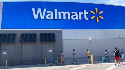 Customers wait in line outside a Walmart Supercenter store, due to COVID-19 restrictions on store capacity, Wednesday, April 7, 2021, in Miami. Walmart is moving more of its workers full time, with the goal of having two-thirds of its U.S. store hourly jobs be full-time with more consistent work schedules by early next year. With this move, announced Wednesday, April 14, the nation’s largest private employer says it will have 740,000 of its 1.2 million U.S. Walmart hourly store workers be full-time by Jan. 31.