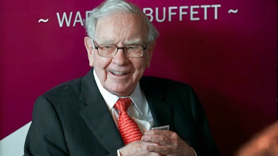 In this May 5, 2019, file photo Warren Buffett, Chairman and CEO of Berkshire Hathaway, smiles as he plays bridge following the annual Berkshire Hathaway shareholders meeting in Omaha, Neb. A multitude of big-name businesses and high-profile individuals, including Buffett, Amazon and Facebook are showing their support for voters’ rights. In a letter published in The New York Times, the group stressed that Americans should be allowed to cast ballots for the candidates of their choice. “For American democracy to work for any of us, we must ensure the right to vote for all of us,” they wrote.