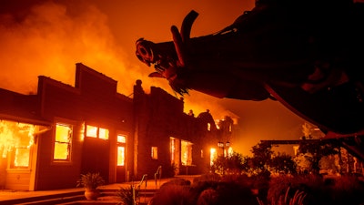 In this file photo, flames from the Kincade Fire consume Soda Rock Winery in Healdsburg, California.