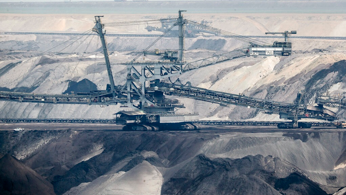 In this Thursday, April 29, 2021 file photo, giant bucket-wheel excavators extract coal at the controversial Garzweiler surface coal mine near Jackerath, west Germany. A report by the International Energy Agency on Tuesday, May 18, 2021 says immediate action is needed to reshape the world’s energy sector in order to meet ambitious climate goals by 2050. This includes ending investments in new coal mines, oil and gas wells.