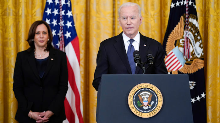 Vice President Kamala Harris listens as President Joe Biden speaks in the East Room of the White House.