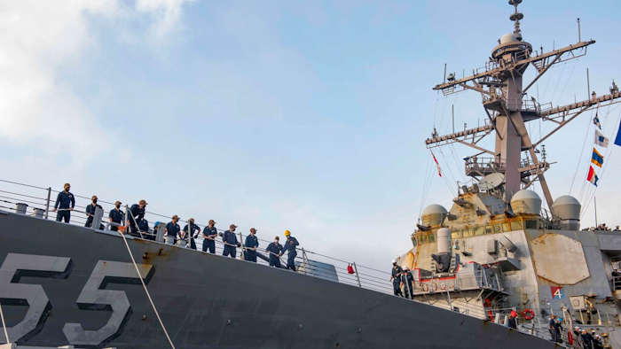 In this photo provided by the U.S. Navy, sailors aboard the guided missile destroyer USS Stout handle mooring lines during the ship's return to home port at Naval Station Norfolk, in Norfolk, Va., in this Oct. 12, 2020, photo. The USS Stout showed rust as it returned from the 210-day deployment. The rust was quickly removed and the ship repainted. But the rusty ship and its weary crew underscored the costly toll of deferred maintenance on ships and long deployments on sailors.