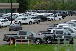 Ford pickup trucks built lacking computer chips are shown in parking lot storage in Dearborn, Mich., Tuesday, May 4, 2021. Automakers are cutting production as they grapple with a global shortage of computer chips, and that's making dealers nervous.