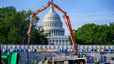 A concrete pump frames the Capitol Dome during renovations and repairs to Lower Senate Park on Capitol Hill in Washington on May 18.