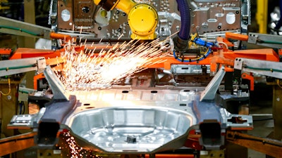 In this June 24, 2019, file photo machines work on a Ford vehicle assembly line at Ford's Chicago Assembly Plant in Chicago.