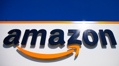In this April 16, 2020, file photo, the Amazon logo is displayed in Douai, northern France. Amazon said Tuesday, May 18, 2021, that it will continue to ban police use of its face-recognition technology beyond the one-year ban it announced last year.