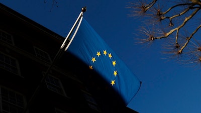 In this file photo dated Friday Jan. 22, 2021, the European Union flag flies outside Europe House in London. Privacy campaign groups Thursday May 27, 2021, have filed a slew of legal complaints with European regulators against Clearview AI, alleging the facial recognition technology it provides to law enforcement agencies and businesses has stockpiled biometric data on more than 3 billion people without their knowledge or permission by “scraping' images from websites, breaching stringent EU privacy rules.