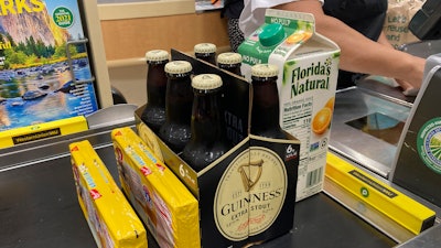 Groceries are shown at a checkout counter, Friday, April 16, 2021, at a grocery store in Surfside, FL.