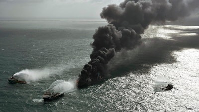 In this photo provided by Sri Lanka Air Force, smoke rises from the container vessel MV X-Press Pearl.