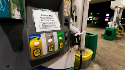 A pump at a gas station in Silver Spring, Md., is out of service, notifying customers they are out of fuel, Thursday, May 13, 2021. Motorists found gas pumps shrouded in plastic bags at tapped-out service stations across more than a dozen U.S. states Thursday while the operator of the nation's largest gasoline pipeline reported making 'substantial progress' in resolving the computer hack-induced shutdown responsible for the empty tanks.