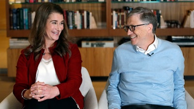 In this file photo, Bill and Melinda Gates smile at each other during an interview in Kirkland, Wash.