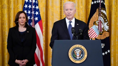 Vice President Kamala Harris listens as President Joe Biden speaks in the East Room of the White House.