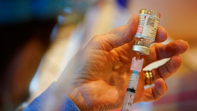 In this Dec. 29, 2020, file photo, Pat Moore, with the Chester County, Pa., Health Department, fills a syringe with Moderna COVID-19 vaccine before administering it to emergency medical workers and health care personnel at the Chester County Government Services Center in West Chester, Pa. Moderna says its COVID-19 vaccine strongly protects kids as young as 12. The company released the preliminary findings Tuesday, May 25, 2021, based on testing on more than 3,700 12- to 17-year-olds in the United States.