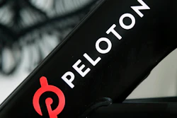 This file photo shows a Peloton logo on the company's stationary bicycle in San Francisco.