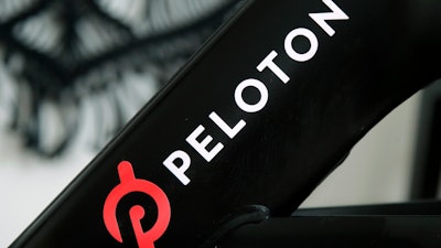 This file photo shows a Peloton logo on the company's stationary bicycle in San Francisco.