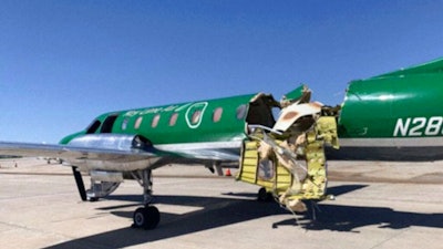 This image from CBS Denver shows a Key Lime Air Metroliner that landed safely at Centennial Airport after a mid-air collision near Denver on Wednesday, May 12, 2021. Federal officials say two airplanes collided but that there are no injuries. The collision between a twin-engine Fairchild Metroliner and a single-engine Cirrus SR22 happened as both planes were landing, according to the National Transportation Safety Board. Key Lime Air, which owns the Metroliner, says its aircraft sustained substantial damage to the tail section but that the pilot was able to land safely.