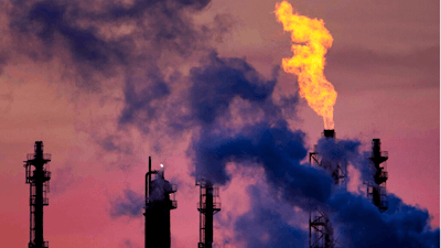 In this Dec.4, 2018 file photo a flame emits from a chimney at the BASF chemical company in Ludwigshafen, Germany.