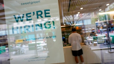 A signs announcing they are hiring hangs in the window of a restaurant in the Greenwich Village neighborhood of Manhattan in New York, Tuesday, May 4, 2021. Some restaurants in New York City are starting to hire employees now that they can increase their indoor dining to 75% of capacity starting May 7.