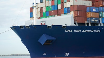 Crew members stand on the bow as the CMA CGM Argentina arrives at PortMiami, the largest container ship to call at a Florida port.