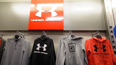In this Nov. 29, 2019, file photo Under Armour clothes are displayed at a Kohl's store in Colma, Calif. Sportswear company Under Armour has settled with the Securities and Exchange Commission to pay $9 million in fines related to misleading its revenue growth to investors from the third quarter of 2015 through the fourth quarter of 2016, the agency said Monday, May 3, 2021.