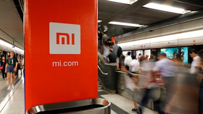 In this July 9, 2018, file photo, an advertisement for Xiaomi is displayed at a subway station in Hong Kong. China’s commerce ministry said Thursday that the removal of Xiaomi Corp. from a U.S. government blacklist was beneficial, a day after the U.S. reversed a ban on U.S. investments in the smartphone maker imposed by former President Donald Trump.