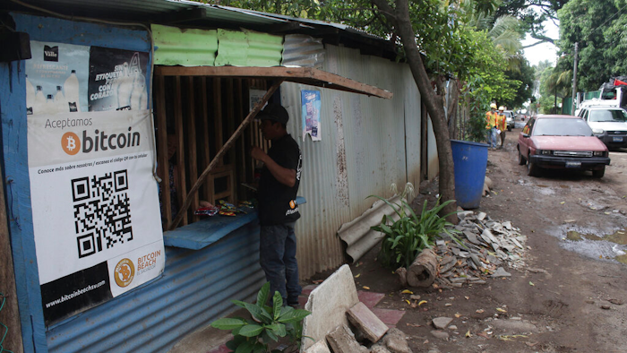 Santos Hilario Galvez makes a purchase at a store that accepts Bitcoin, Tamanique, El Salvador, June 9, 2021.
