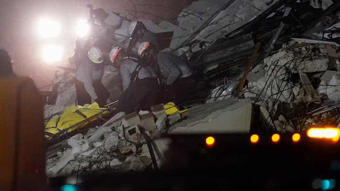 Rescue workers remove a body from the rubble where a wing of a 12-story beachfront condo building collapsed, Thursday, June 24, 2021, in the Surfside area of Miami.