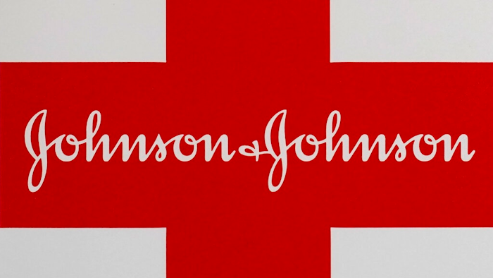 This Feb. 24, 2021 photo shows a Johnson & Johnson logo on the exterior of a first aid kit in Walpole, Mass. The New York attorney general says Johnson & Johnson has agreed to pay $230 million to settle claims that the pharmaceutical giant helped fuel the opioid crisis. The deal requires Johnson & Johnson to make a series of payments over nine years to cover total.