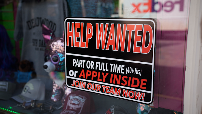In this May 26, 2021 photo, a sign for workers hangs in the window of a shop along Main Street in Deadwood, S.D. U.S. employers added 559,000 jobs in May, an improvement from April’s sluggish gain but still evidence that many companies are struggling to find enough workers as the economy rapidly recovers from the pandemic recession.